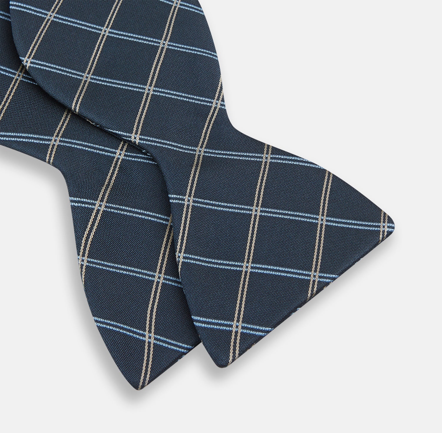 View 3 of product The Turnbull & Asser Navy Triple Check Silk Bow Tie features a navy, light blue, and beige plaid pattern on white, offering British elegance for those who value formal style.
