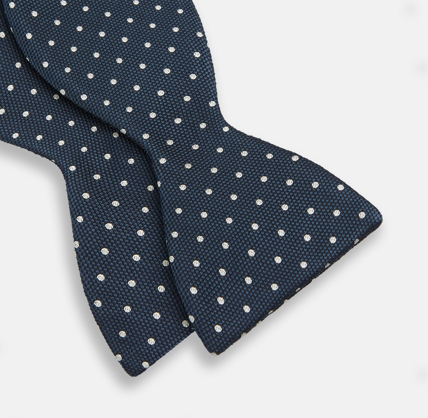View 3 of product The Turnbull & Asser Navy Micro Dot Silk Bow Tie, shown on a white background, embodies British sophistication and classic formal style.