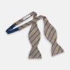 View 2 of product The Brown Puppytooth Stripe Silk Bow Tie by Turnbull & Asser features a houndstooth pattern in brown, beige, and burgundy with navy stripes—an elegant choice for formal occasions. Shown on a crisp white background.