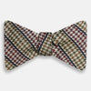 View 1 of product The Brown Puppytooth Stripe Silk Bow Tie by Turnbull & Asser features a houndstooth pattern in brown, beige, and burgundy with navy stripes—an elegant choice for formal occasions. Shown on a crisp white background.