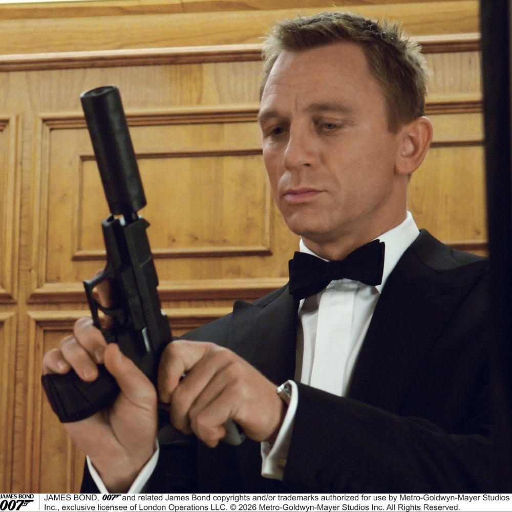 The Casino Royale Shantung Silk Bow Tie by Turnbull & Asser, as seen on James Bond, features a classic shape in black silk and is set against a plain white background—a timeless gentleman’s accessory.