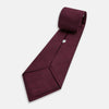 View 5 of product A close-up of the Turnbull & Asser UK Seven-Fold Navy and Red Silk Tie, featuring a small textured check pattern reminiscent of houndstooth, displayed on a plain white background.
