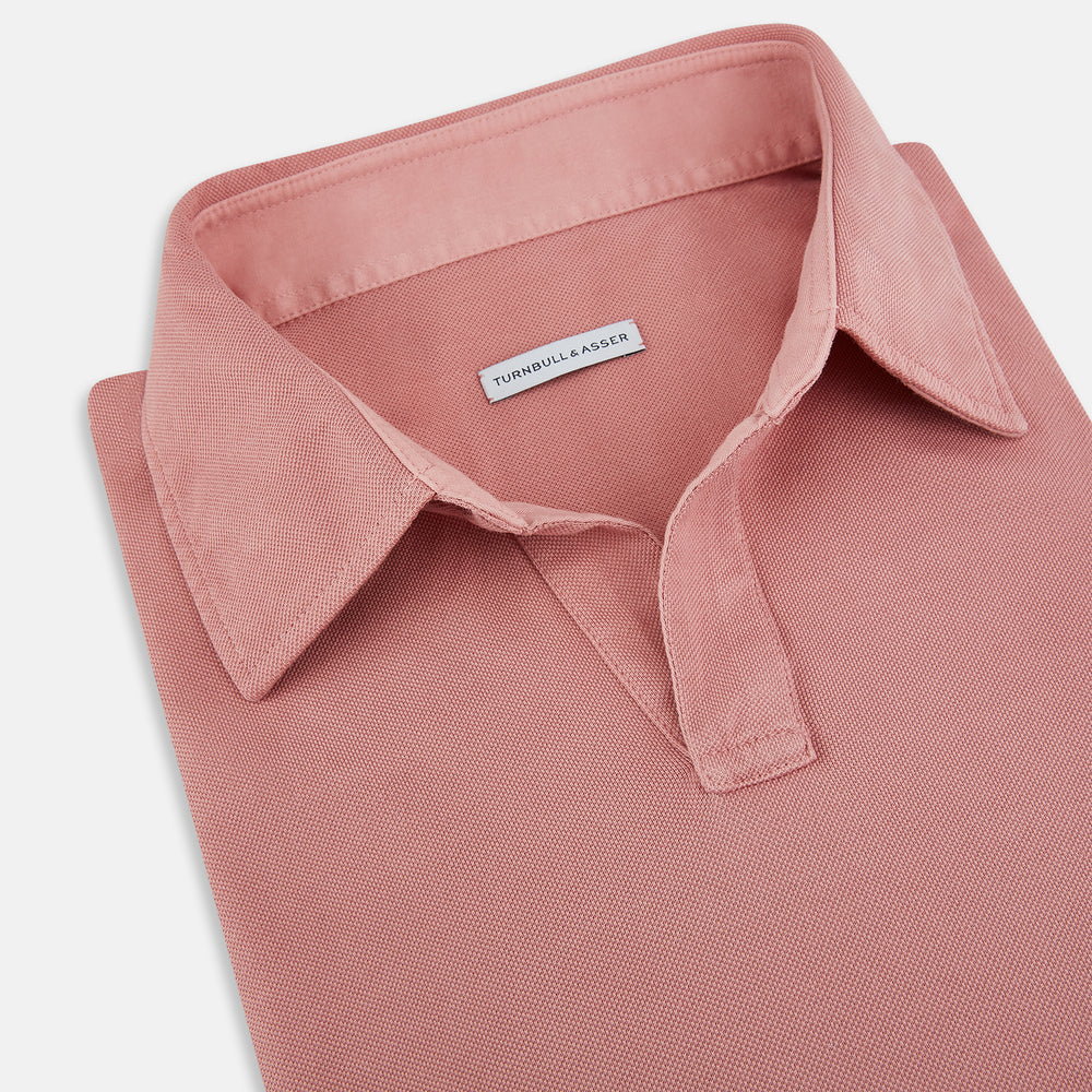 A Turnbull & Asser Red Rugby Polo Shirt with long sleeves, a collared neckline, v-neck opening, and no buttons is laid flat on a white background.