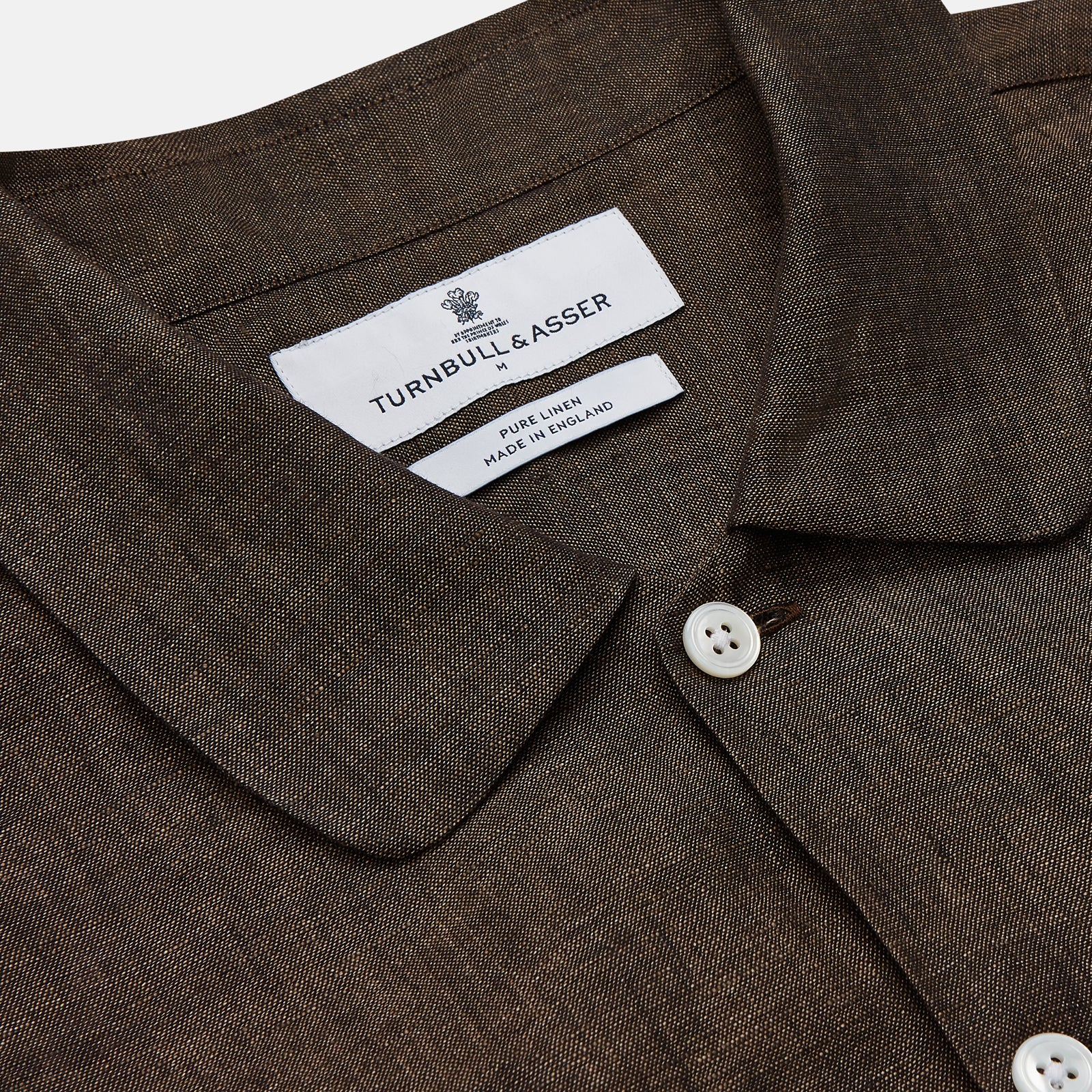 View 3 of product The Turnbull & Asser Chocolate Brown Linen Holiday Fit Fellows Shirt, featuring long sleeves, a classic collar, and white buttons, is displayed flat on a white background—ideal for effortless summer style.
