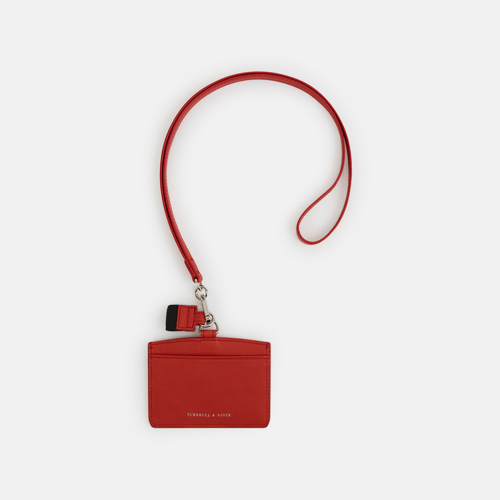 The Red ID Card Holder by Turnbull & Asser is crafted from Italian leather with a matching lanyard and a small key charm. The brand’s name is embossed in white on the front for an elegant finish.