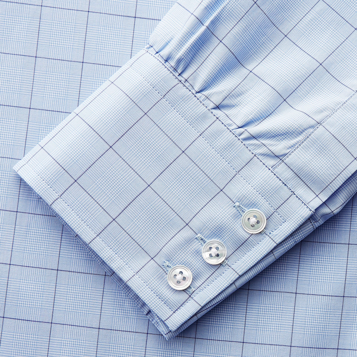 View 4 of product The Blue Prince of Wales Check Mayfair Shirt by Turnbull & Asser features a light blue check pattern, white buttons, and a classic collar. Crafted from premium Italian cotton, it is displayed on a plain white background.