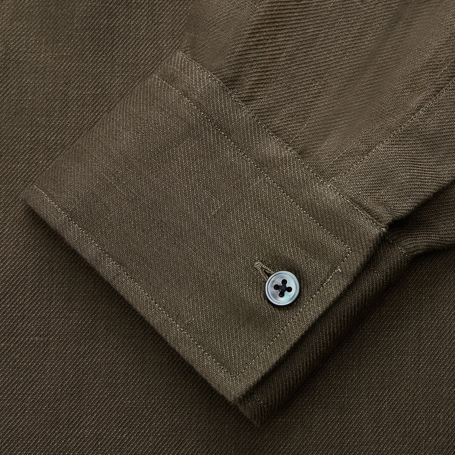 View 3 of product The Turnbull & Asser Khaki Green Linen Weekend Fit Langston Shirt features long sleeves, a classic Derby collar, two chest pockets, and buttoned cuffs, shown against a white background.