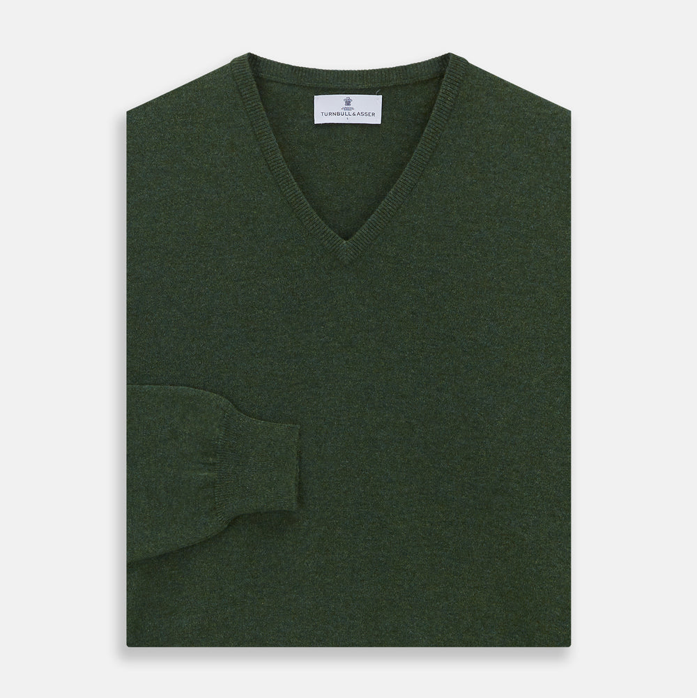 The Turnbull & Asser Green V-Neck Cashmere Jumper, made from soft Scottish cashmere, features long sleeves with ribbed cuffs and a ribbed hem. It is shown laid flat on a white background.