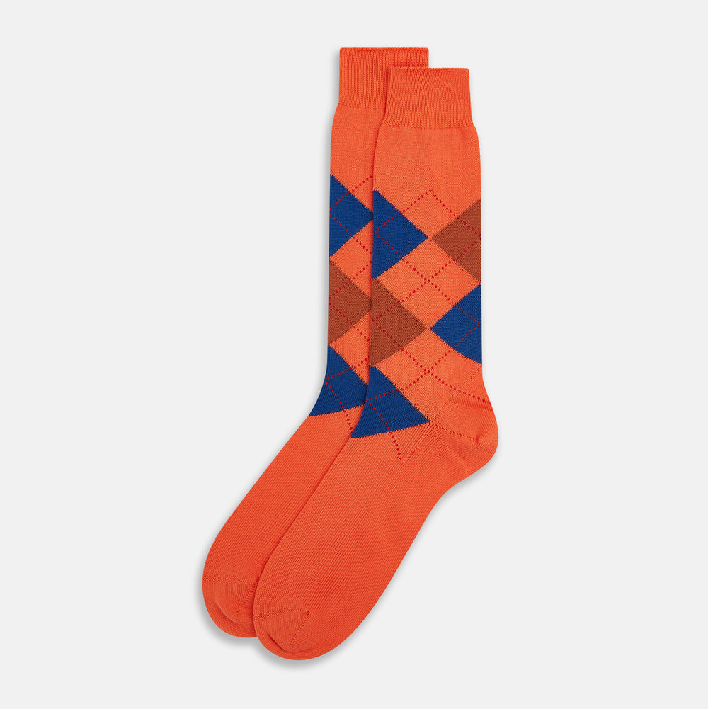 Turnbull & Asser's Royal Blue and Orange Patterned Mid-Length Socks feature an argyle design with brown, blue, and orange diamonds, shown against a plain white background.