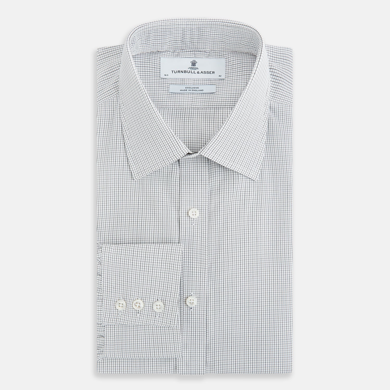 View 5 of product A tailored-fit Turnbull & Asser Mayfair Shirt in midnight blue with a grid check pattern, spread collar, and buttoned cuffs, crafted from premium Italian cotton and laid flat on a white background.