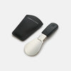 View 3 of product The Turnbull & Asser Navy Travel Shoe Horn features a wide, smooth silver blade and a navy leather-wrapped handle, shown against a plain white background.