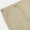 View 2 of product Turnbull & Asser's Taupe Linen Henry Trousers, made from a linen-cotton blend, feature a straight-leg cut, button and zip closure, belt loops, and adjustable waist tabs—shown against a plain white background.