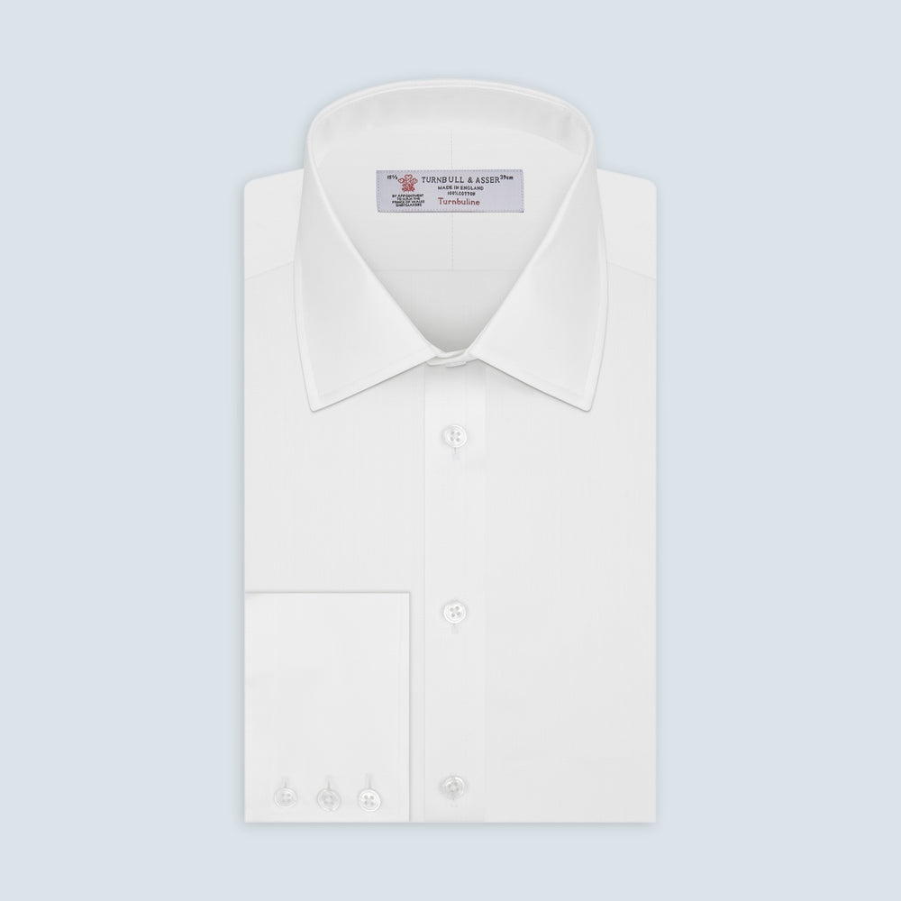 The Turnbull & Asser White Herringbone Superfine Cotton Shirt with T&A collar and 3-button cuffs is perfect for pairing with statement ties or elevating minimalist looks.