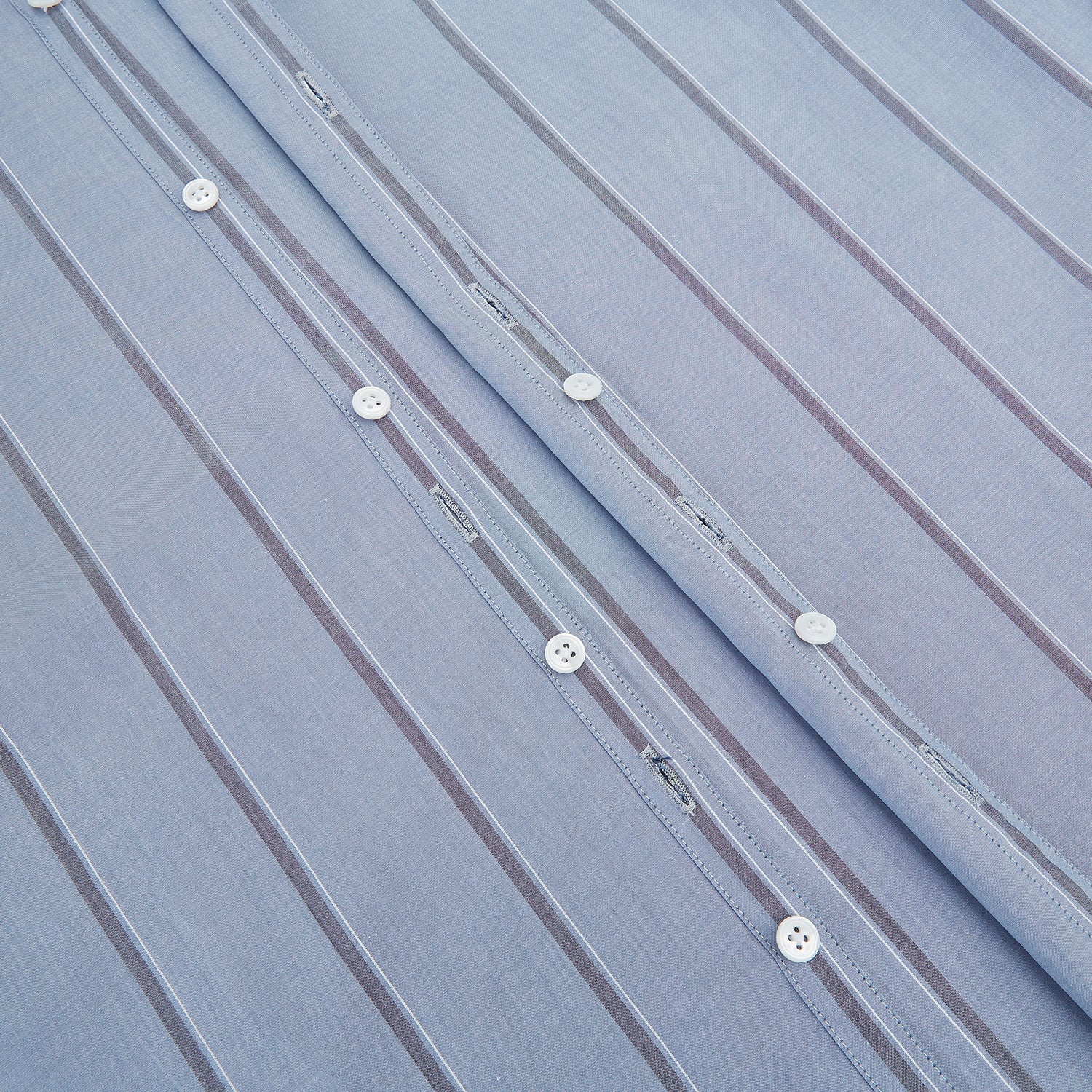 View 7 of product The Steel Blue Track Stripe Westminster Shirt by Turnbull & Asser features dark pinstripes, a classic collar, white buttons, and buttoned cuffs—expertly crafted to highlight British craftsmanship. Laid flat on white background.