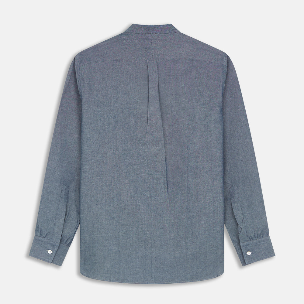 The Turnbull & Asser Plain Blue Oxford Cotton Weekend Fit Blake Shirt features long sleeves, a stand collar, and white buttons, displayed flat on a white background.