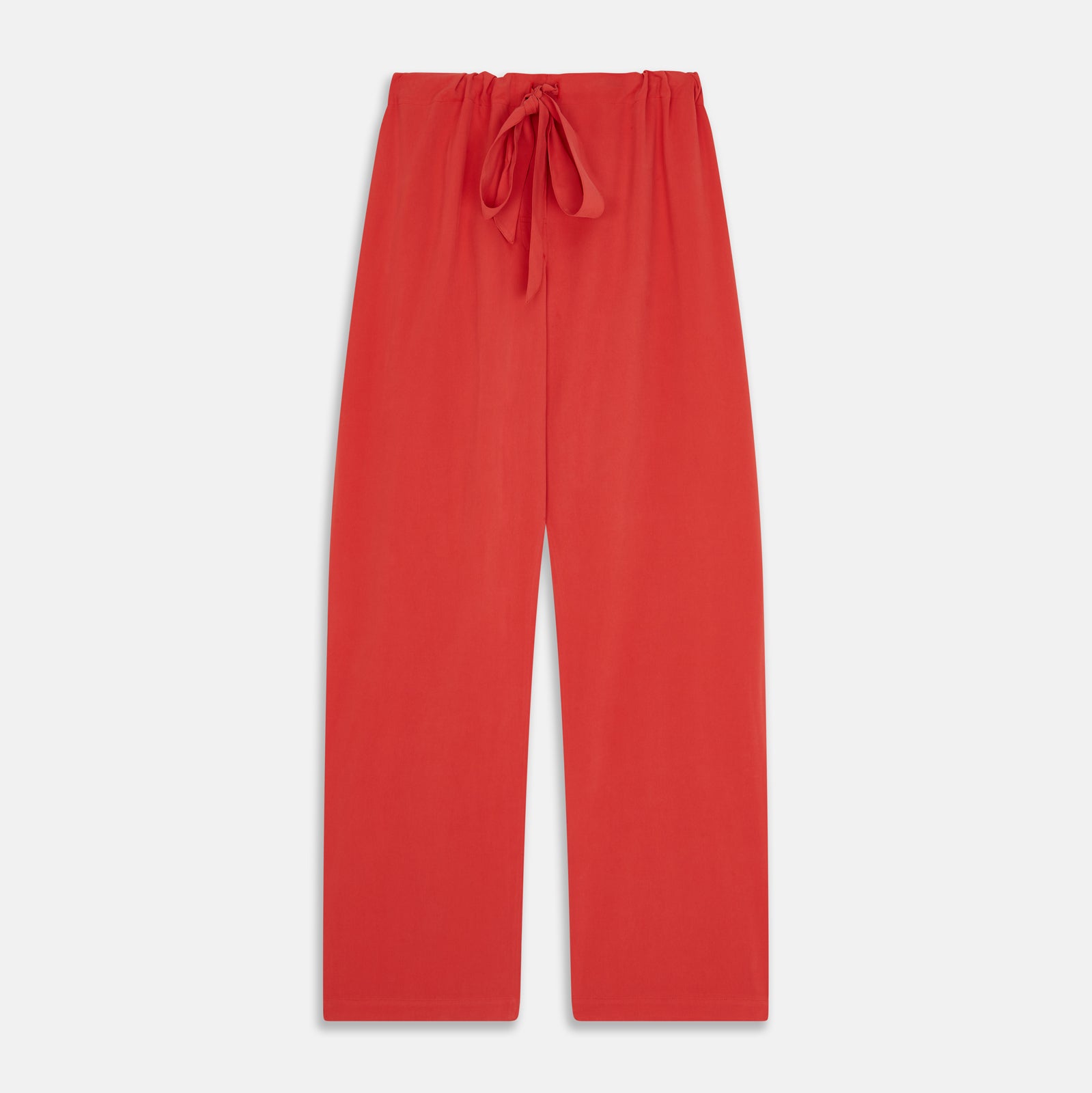 View 6 of product The Turnbull & Asser Women's Coral Pink Silk Thelma Pyjama Set features a long-sleeve button-up top with two front pockets and matching drawstring pants, shown on a white background.