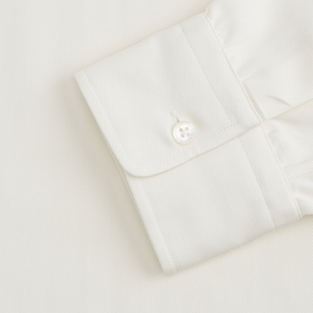 The Turnbull & Asser Cream Cotton Weekend Fit Unwin Shirt features long sleeves, a stand collar, and two chest pockets, shown laid flat on a white background.