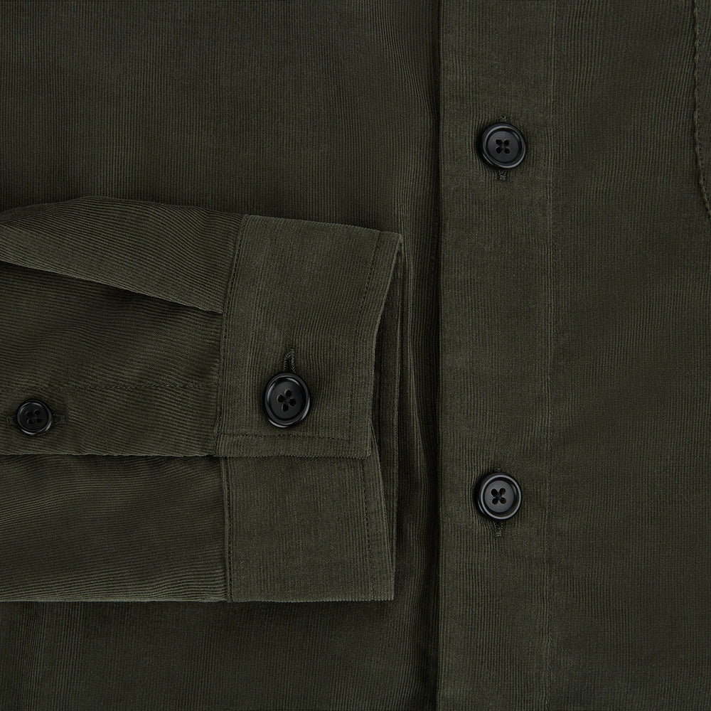 The Turnbull & Asser Olive Corduroy Hampstead Overshirt for men features a collar, long sleeves, left chest pocket, and two zippered side pockets, shown laid flat on a white background.