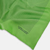 View 2 of product The Fern Green Stripe Silk Pocket Square by Turnbull & Asser features thin black vertical stripes, celebrates British heritage, and is inscribed “TURNBULL & ASSER HAND PRINTED IN ENGLAND” in one corner; one corner is folded inward.