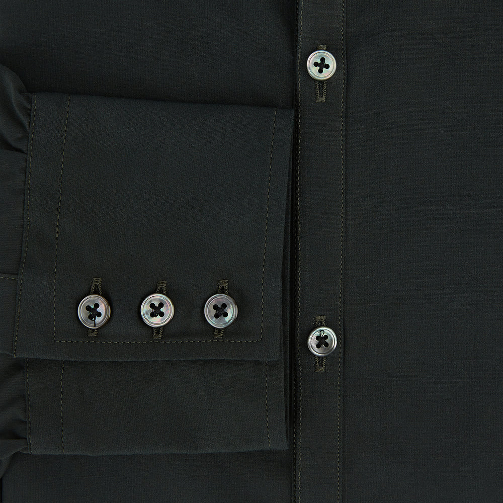 The FOREST GREEN WINDSOR SHIRT by Turnbull & Asser features long sleeves, a Windsor collar, and buttoned cuffs, reflecting British craftsmanship. Displayed on a plain white background.