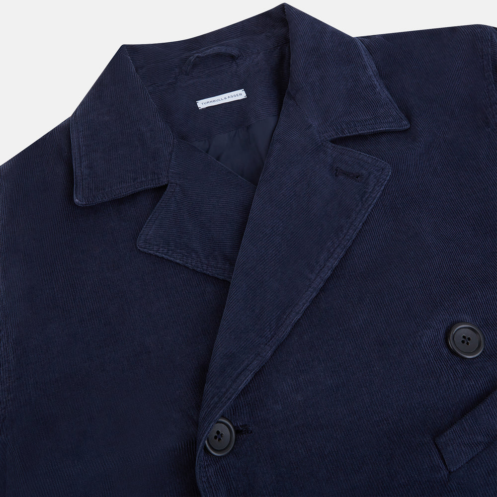 The Turnbull & Asser Light Navy Kingston Corduroy Caban Jacket features a double-breasted stretch cotton corduroy design with black buttons, notched collar, and long buttoned cuffs, displayed on a plain white background.