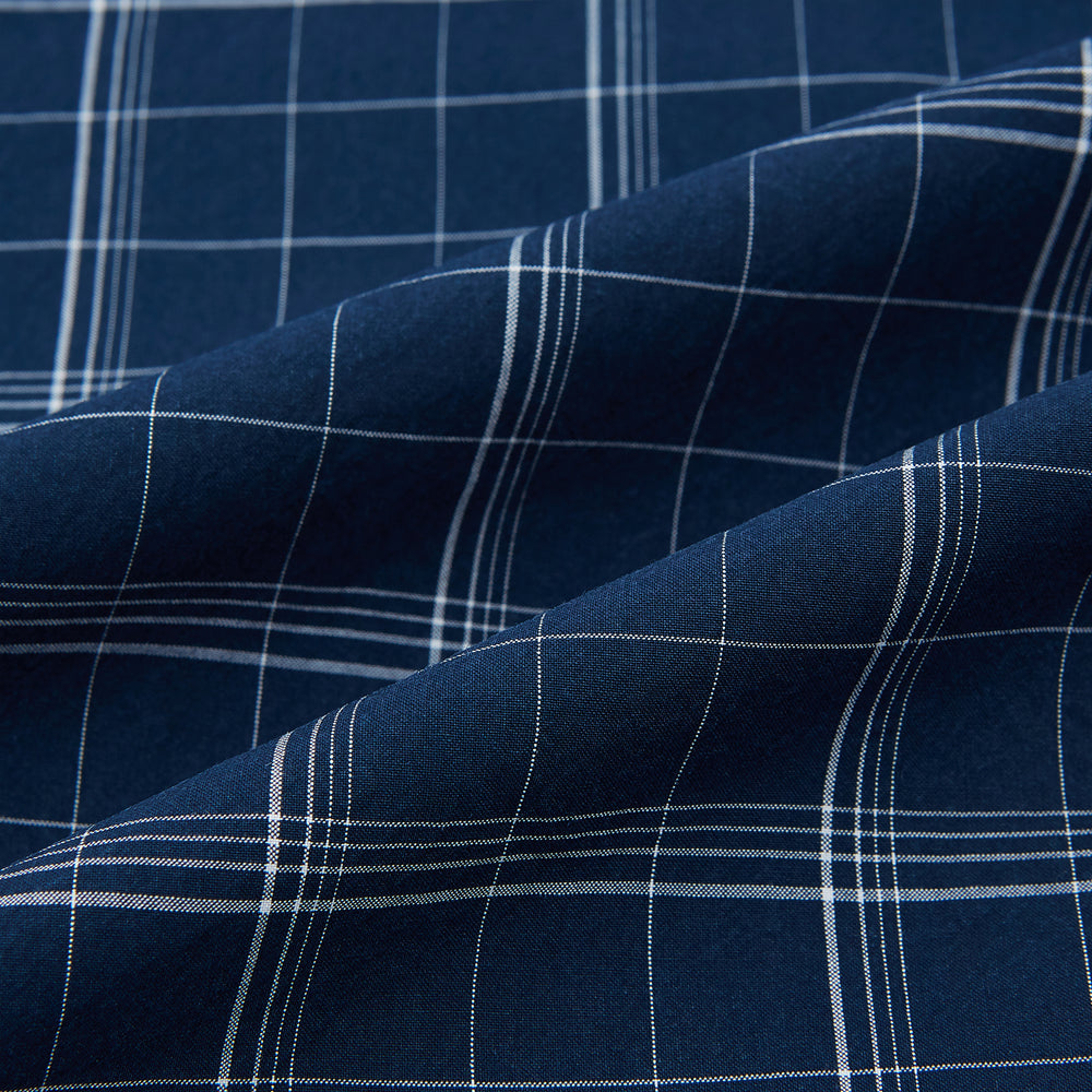 The Turnbull & Asser Indigo Windowpane Check Windsor Shirt features a contrast T&A collar and cuffs, highlighting British craftsmanship. It is displayed flat on a white background.