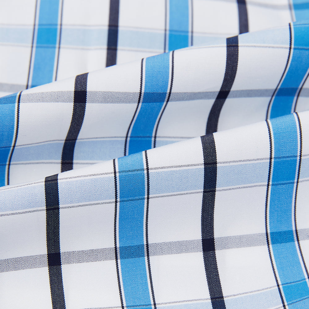 The Turnbull & Asser Blue and Navy Combination Check Mayfair Shirt features a classic button-up style with long sleeves, T&A collar, and a blue, navy, and white check pattern, shown against a plain white background.