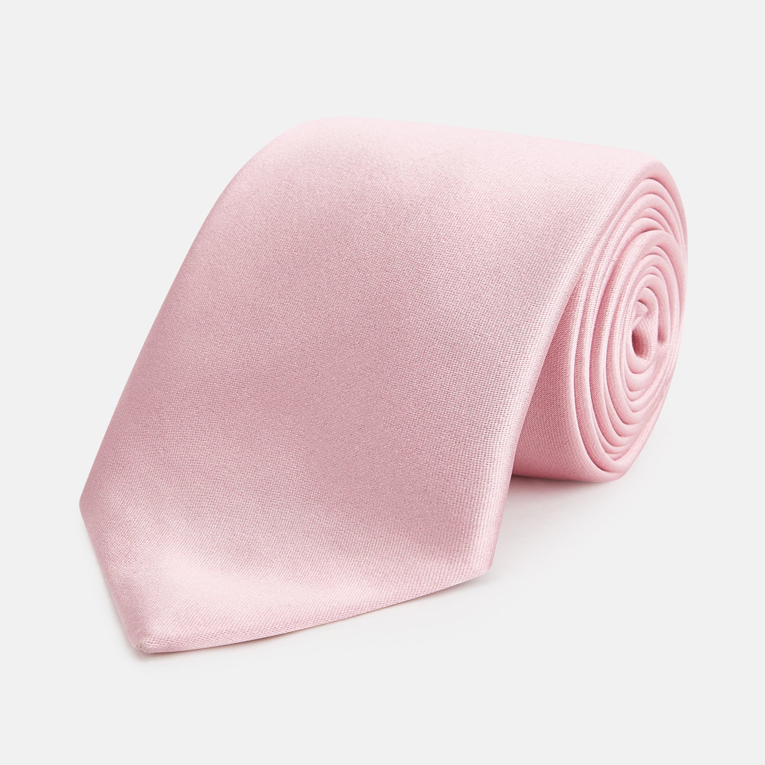 View 1 of product The Turnbull & Asser PINK PLAIN SATIN SILK TIE is neatly rolled and showcased against a plain white background.