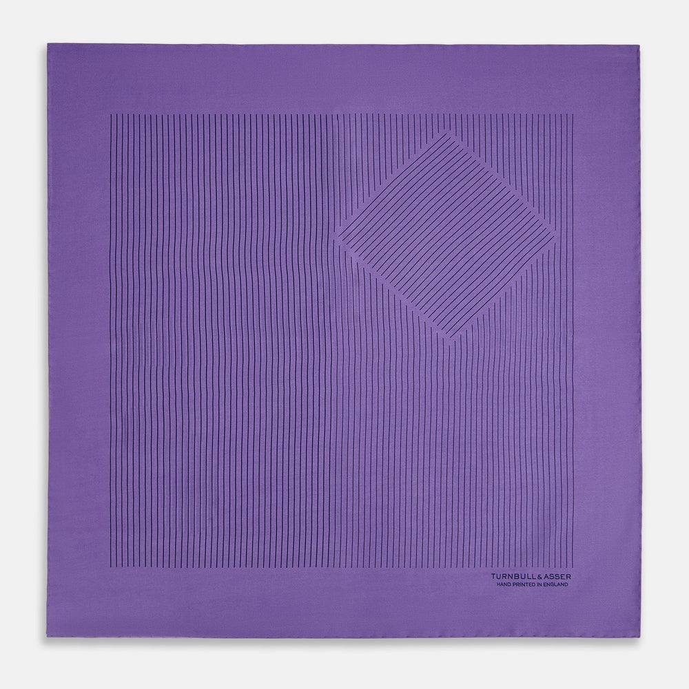 The Purple Stripe Silk Pocket Square by Turnbull & Asser features thin black lines on purple silk—a sophisticated blazer accessory hand printed in England, showcasing classic British craftsmanship.