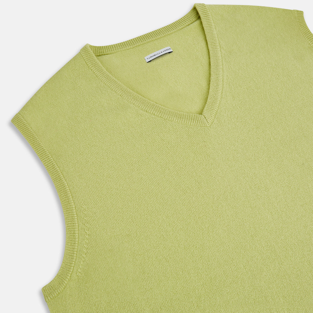 Turnbull & Asser’s Melon Green V-neck Cashmere Vest is shown on a plain white background. This sleeveless men’s jumper features ribbed neckline, armholes, and hem for subtle detail.