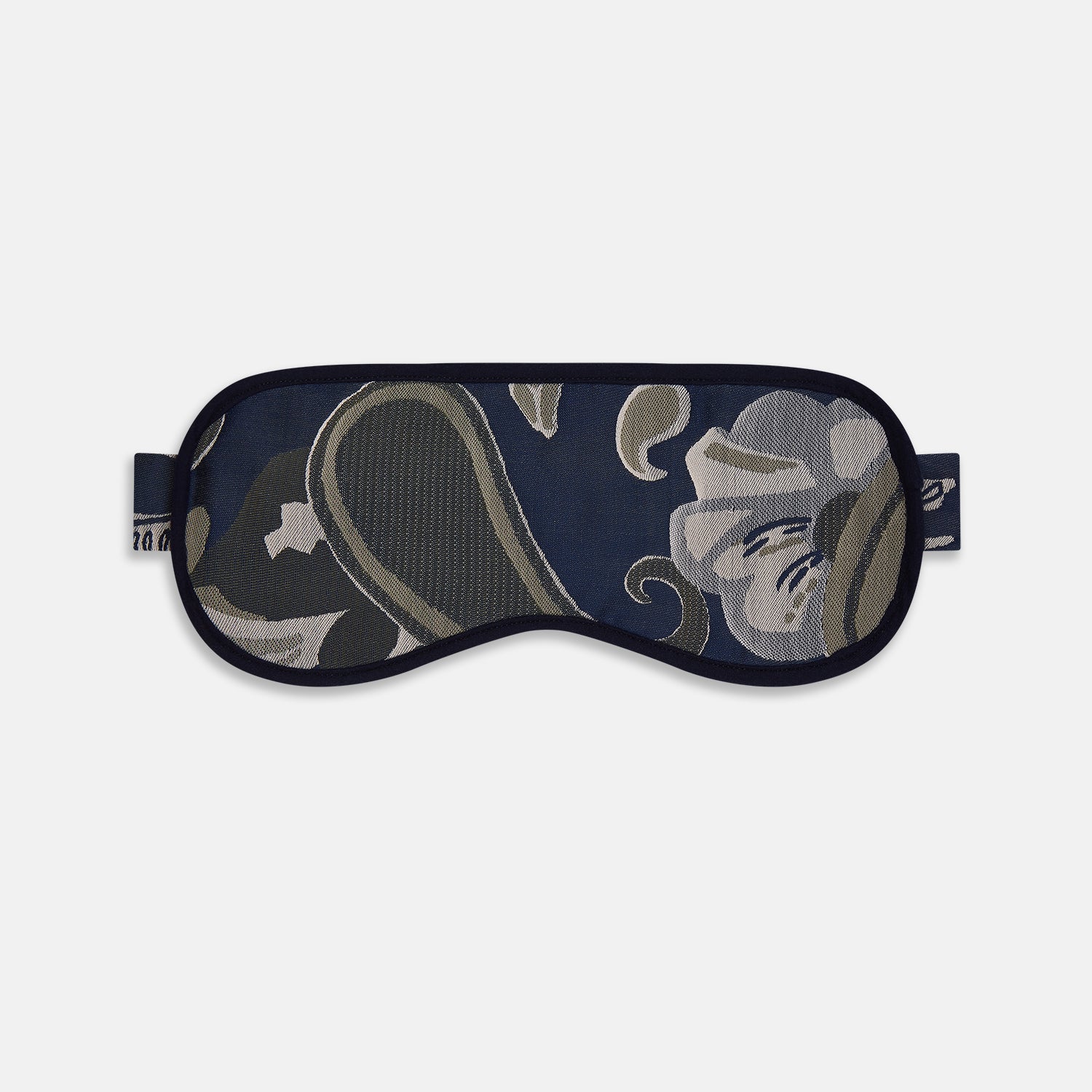 View 1 of product The Turnbull & Asser Navy Bloomsbury Jacquard Cashmere Lined Sleep Mask and Bag features a dark blue backdrop with beige, olive green, and gray floral patterns, plus elastic straps for comfort.