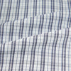 View 6 of product The Turnbull & Asser Navy Multi Check Mayfair Shirt is made from pure cotton with a blue and white check pattern, long sleeves, pointed collar, and buttoned cuffs, shown against a white background.