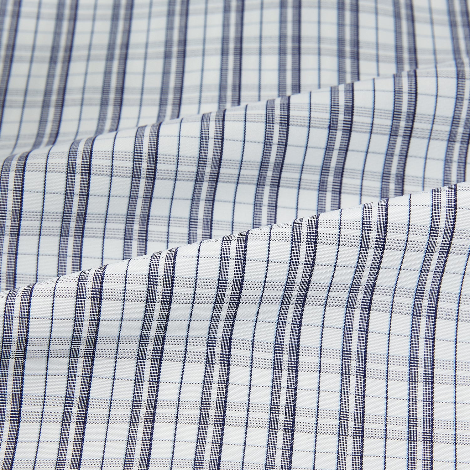 View 6 of product The Turnbull & Asser Navy Multi Check Mayfair Shirt is made from pure cotton with a blue and white check pattern, long sleeves, pointed collar, and buttoned cuffs, shown against a white background.