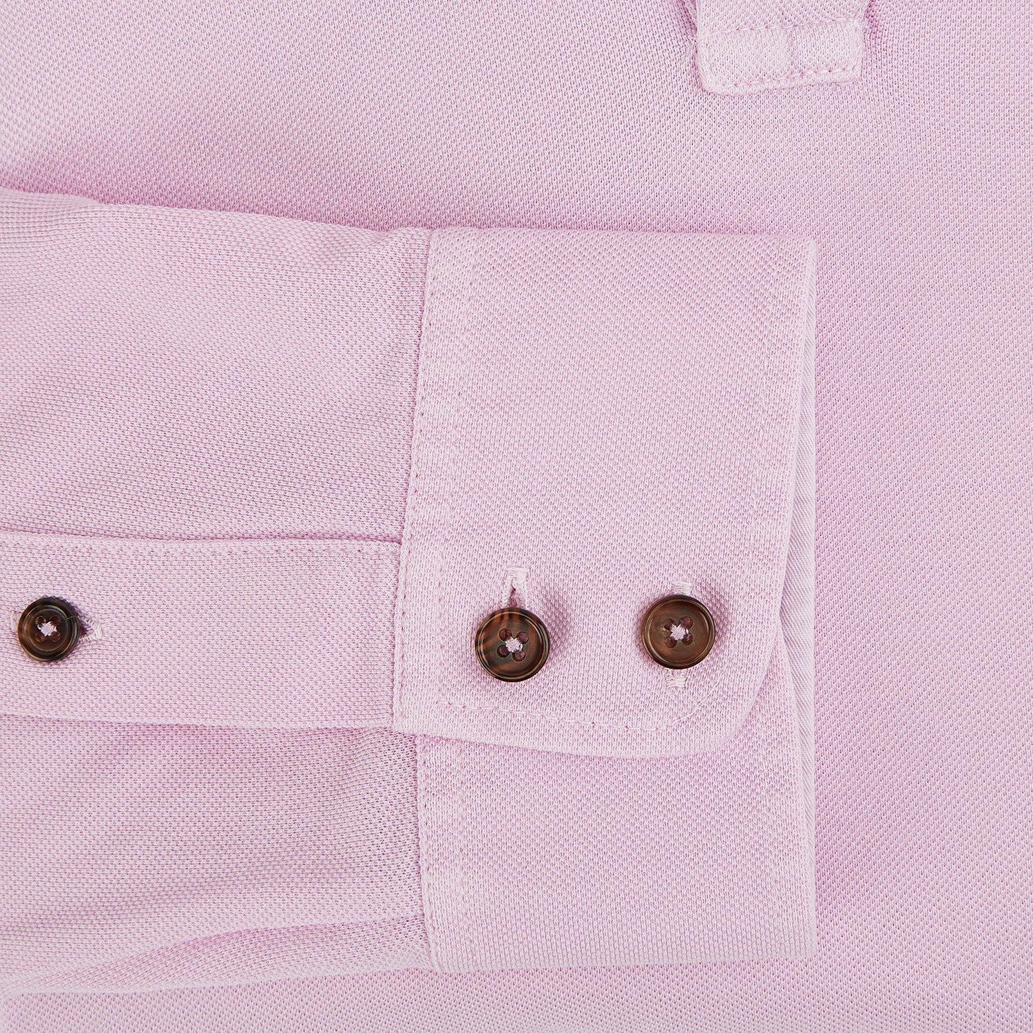 View 4 of product The Pink Rugby Polo Shirt by Turnbull & Asser features long sleeves, a collar, and V-neck opening in luxury cotton, shown flat on a white background.