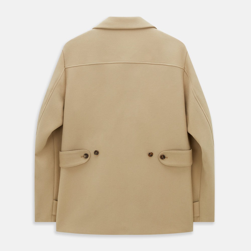 The Camel Wellington Double-Breasted Caban Coat by Turnbull & Asser features wide lapels, dark buttons, front flap and chest pockets, plus buttoned cuffs—perfect for elevating your formal wear collection.