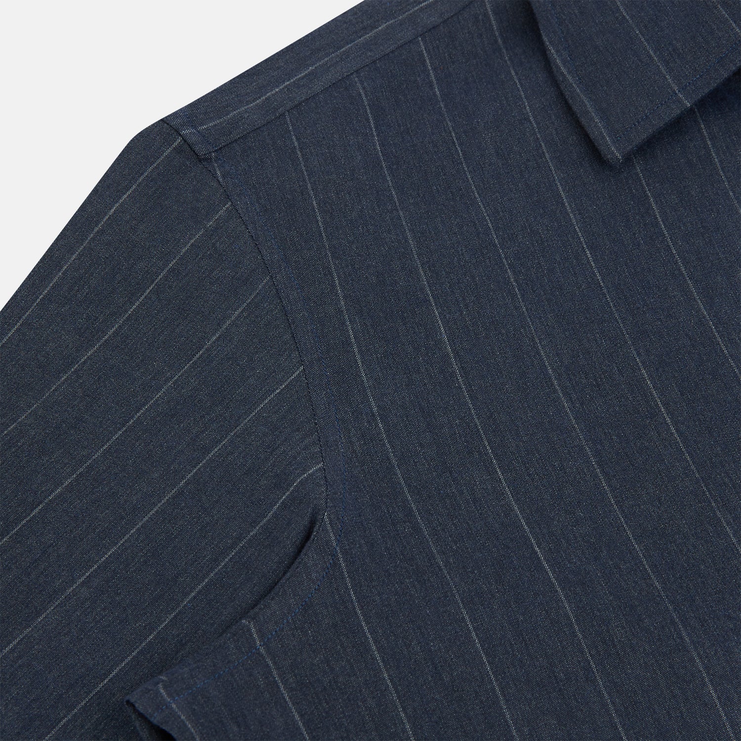 View 6 of product The Turnbull & Asser Navy Melange Wide Stripe Westminster Shirt features a classic collar, buttoned cuffs, and a tailored fit, showcasing British craftsmanship. Laid flat on a white background.