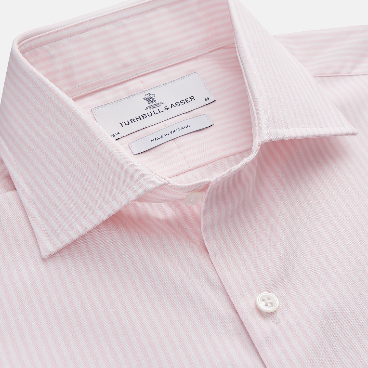 View 2 of product The Turnbull & Asser White and Pink Wide Stripe Shirt with Double Cuffs features a minimalist design, with bold vertical stripes and long sleeves, shown laid flat against a white background.
