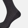 View 4 of product Turnbull & Asser Grey Motif Mid-Length Sock, crafted from Egyptian cotton, features a fine white geometric dot pattern on grey with a solid black cuff, heel, and toe for classic style. Displayed on a white background.