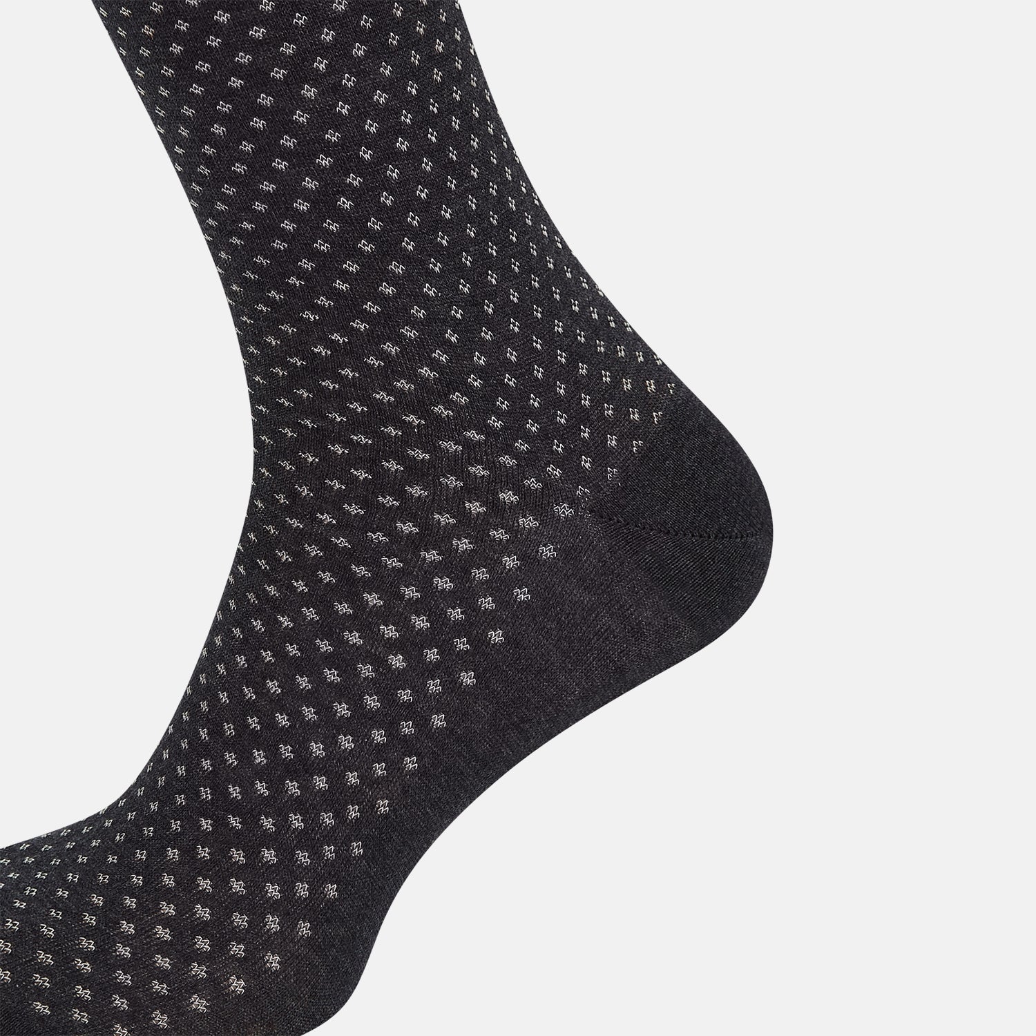 View 4 of product Turnbull & Asser Grey Motif Mid-Length Sock, crafted from Egyptian cotton, features a fine white geometric dot pattern on grey with a solid black cuff, heel, and toe for classic style. Displayed on a white background.