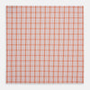View 3 of product The Turnbull & Asser Hand Rolled Orange Graph Overlay Check Handkerchief features bold orange and white checks with blue and orange grid lines—a refined, classic accessory for any gentleman.