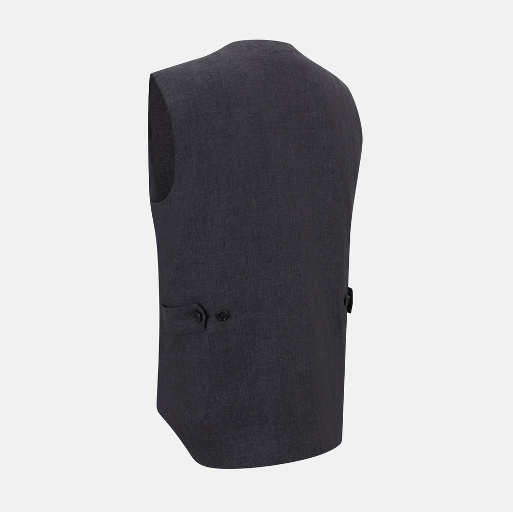 The Turnbull & Asser Ash Linen Twill Waistcoat is a dark gray, sleeveless V-neck with three front buttons, a chest pocket, and two diagonal zippered pockets in subtly textured twill. Shown on a plain white background.