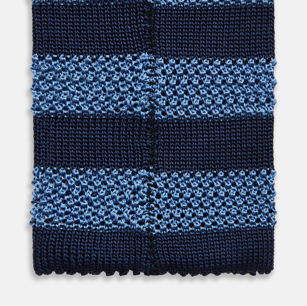 The Turnbull & Asser Navy and Blue Square tipped knitted tie features horizontal stripes and a rolled-up silk design, elegantly displayed on a plain white background.