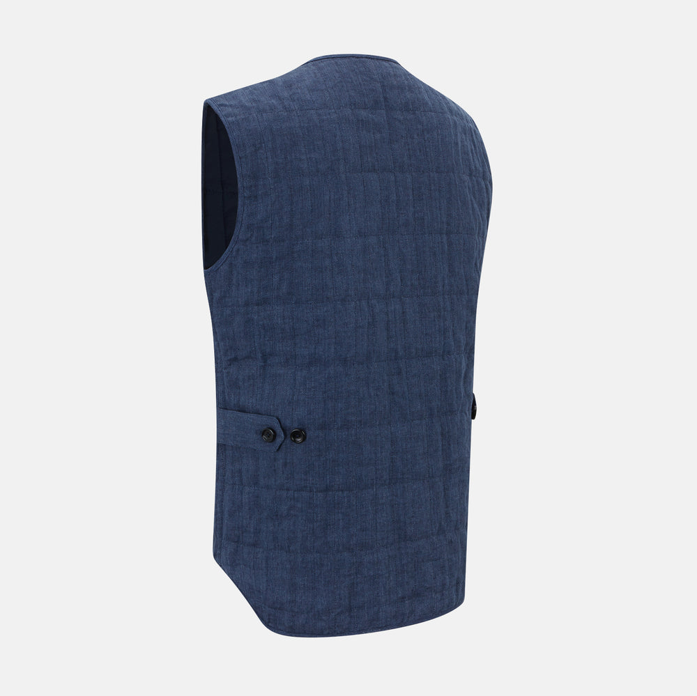 The Denim Blue Quilted Linen Herringbone Waistcoat by Turnbull & Asser features a sleeveless design, five black buttons, two zippered side pockets, and a small chest pocket against a plain white background.