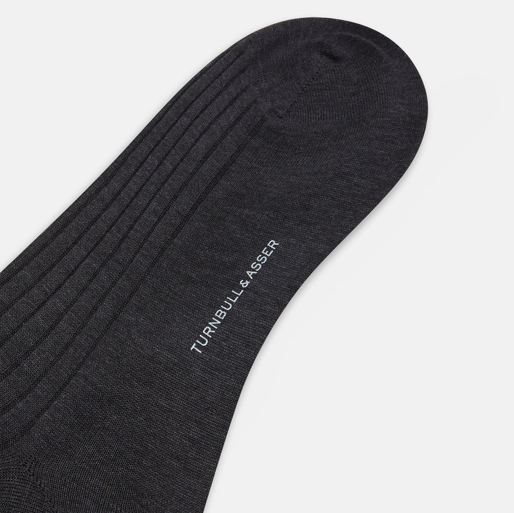 A single Charcoal Mid-Length Sock by Turnbull & Asser, crafted from mercerised Egyptian cotton in dark brown flat-knit, is displayed upright against a plain white background.