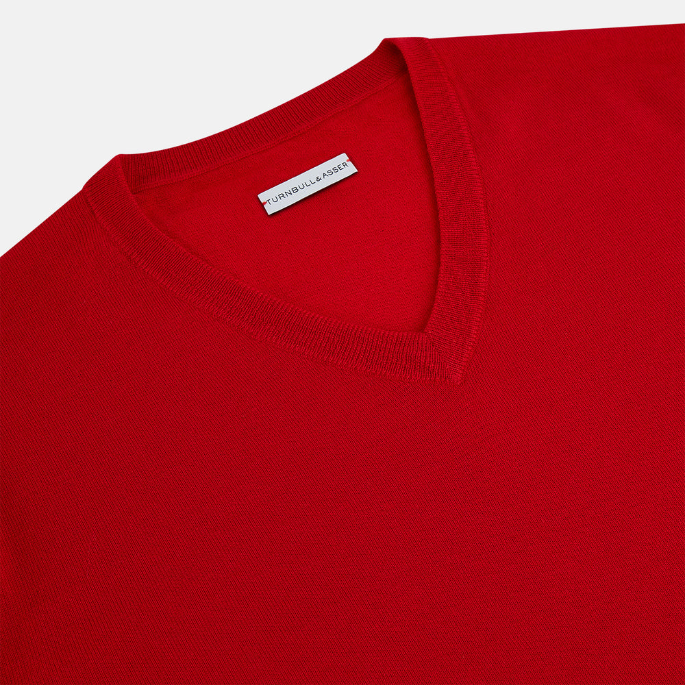 The Turnbull & Asser Red Fine Merino V-Neck Jumper, a classic long-sleeve knitwear piece, is shown on a white background.