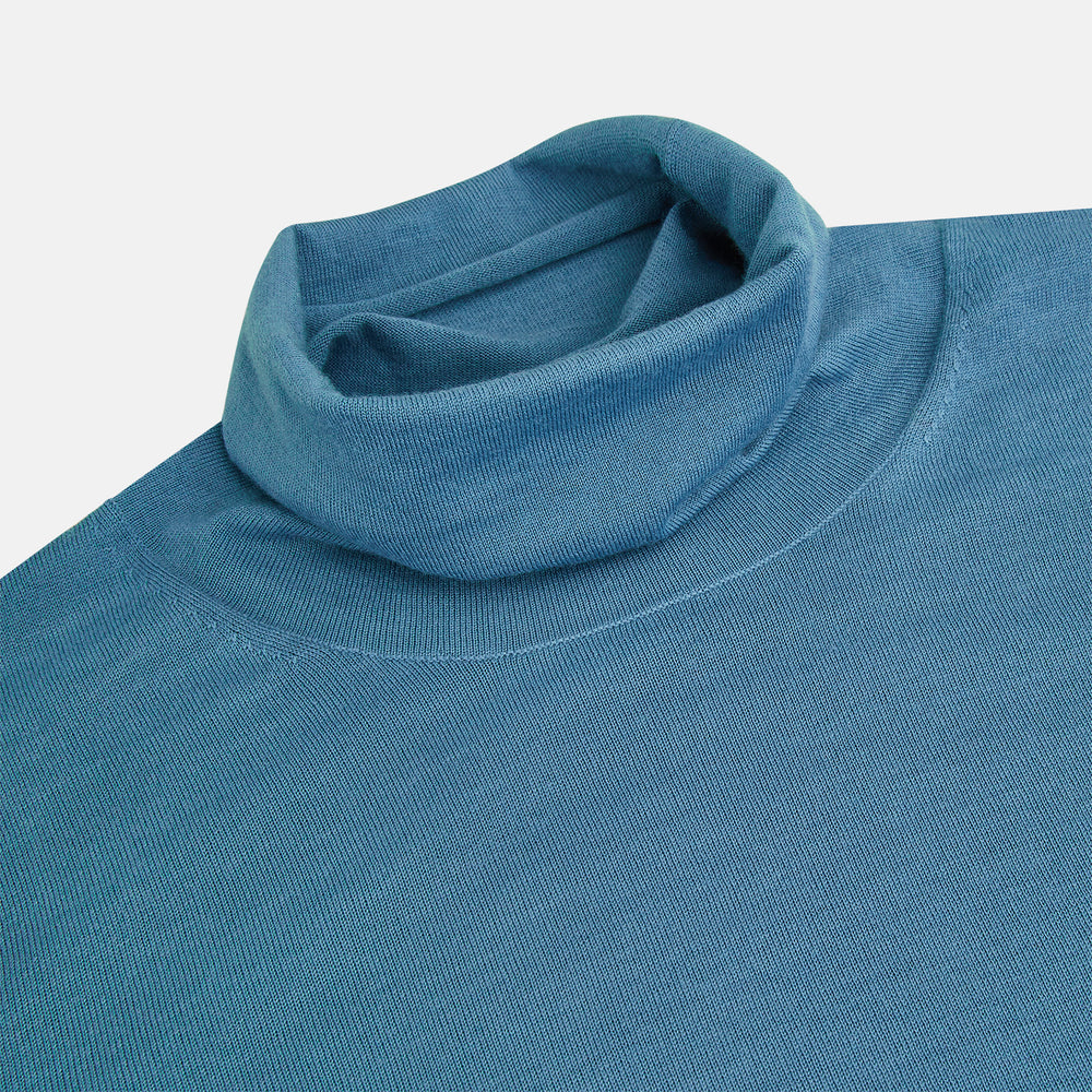 Turnbull & Asser's Pale Blue Fine Merino High Neck Jumper is shown on a plain white background, featuring a simple, classic design with long sleeves and no visible patterns or embellishments.
