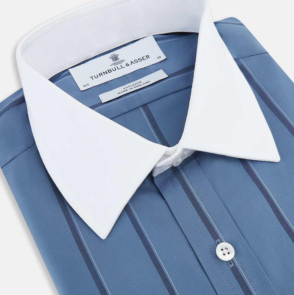 The Turnbull & Asser Steel Grey Track Stripe Shirt features vertical black stripes, a contrast white T&A collar, and white cuffs, shown against a plain light background.