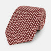 View 1 of product The Turnbull & Asser Burgundy Flower Patterned Silk Tie features a repeating white and light pink floral motif, shown against a plain white background.