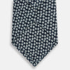 View 3 of product The Turnbull & Asser Navy Flower Patterned Printed Silk Tie features a repeating design of small white and light blue floral motifs on navy silk.