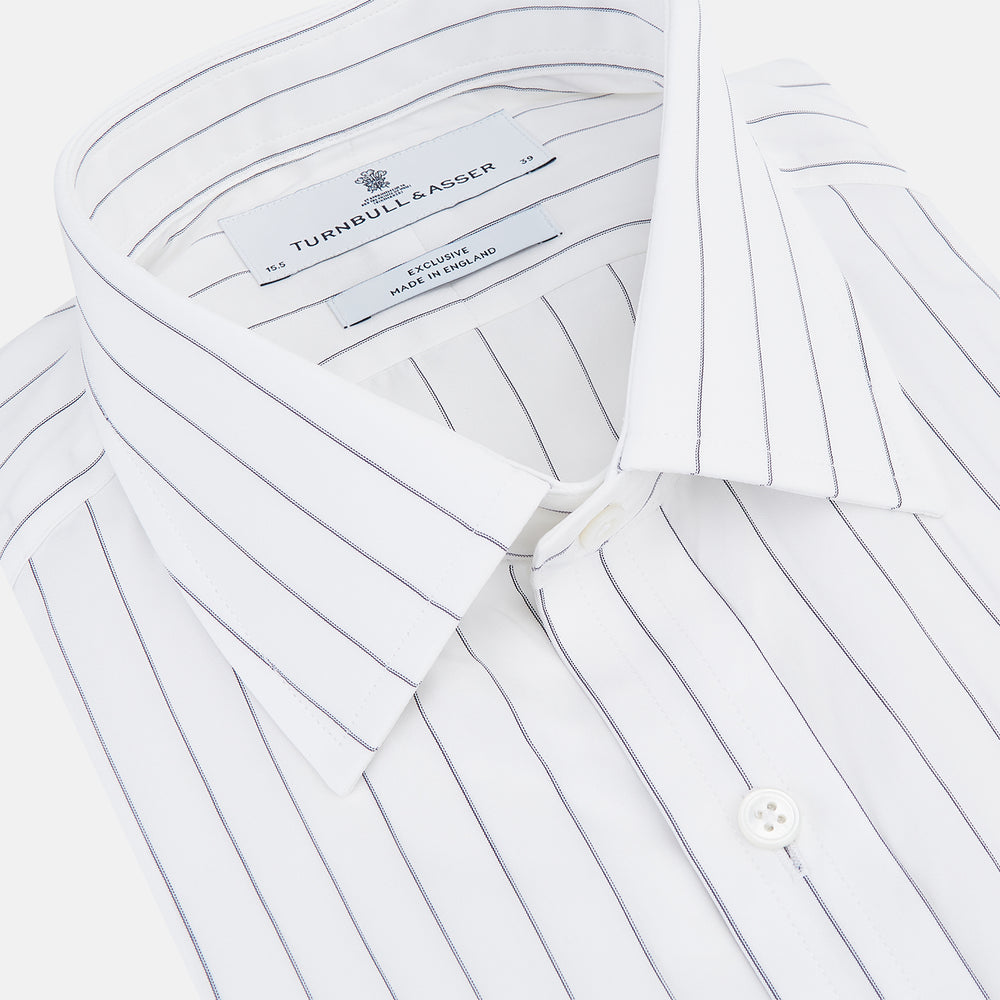 The Turnbull & Asser Navy Hairline Multi Stripe Mayfair Shirt, made from fine Italian cotton with navy stripes, a pointed collar, and buttoned cuffs, is shown laid flat on a plain white background.